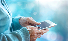 An elderly lady's hands on a smartphone