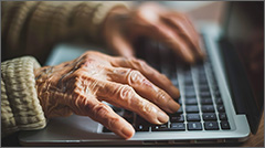 Elderly person using laptop