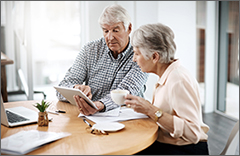 Elderly couple looking at a tablet